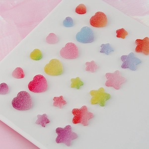 Macro view of gradient gummy star and heart resin charms with sugar-coated texture