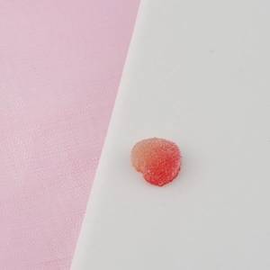 Macro detail of gradient heart resin charm with a frosted texture for DIY craft making
