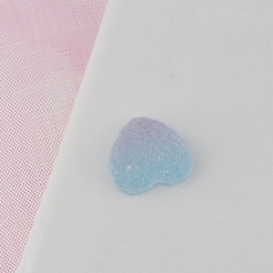 Macro detail of blue and pink gradient heart candy resin charm with sugar grain texture