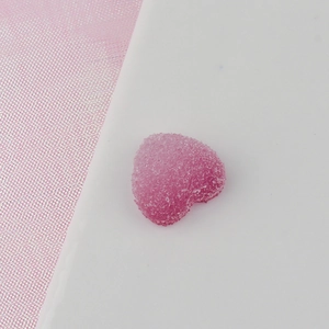 Detail of pink heart-shaped resin bead with crystal sugar coating for DIY crafts