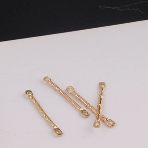 Macro shot of gold hammered metal double-hole connector bars for DIY jewelry making