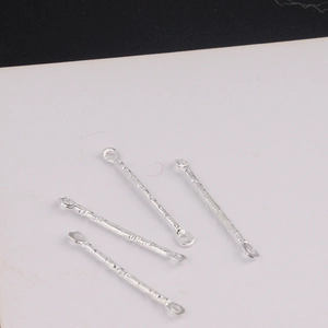 Macro shot of four silver connector bars with dual hanging holes and hammered texture