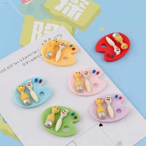 Detailed close-up of colorful resin art palette charms for DIY phone case and crafts