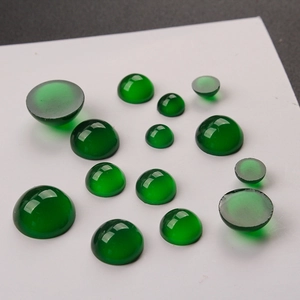 Close-up of polished dark green faux agate resin dome beads for jewelry making