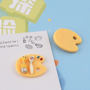 Macro detail of miniature resin paint palette charms for DIY phone case crafts