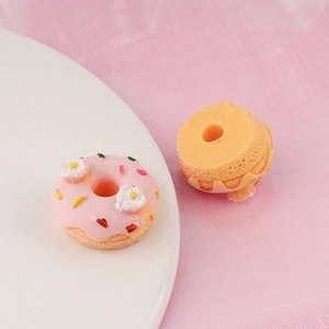 Macro shot of miniature resin flower donuts showing detailed texture for DIY crafts