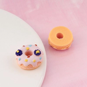 Macro detail of miniature resin donut and macaron charms for DIY resin phone case crafts