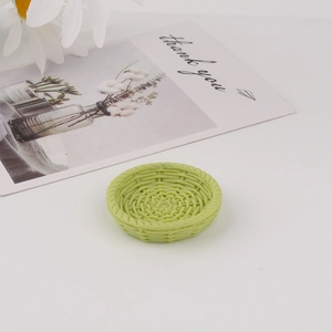 Close-up of a light green miniature round tray with realistic woven texture for DIY crafts