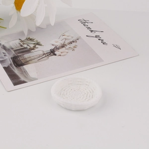 Detailed top view of miniature white resin woven basket with intricate vine texture