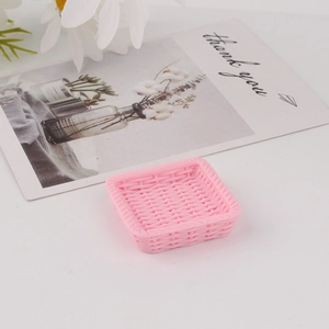 Detailed view of a pink resin mini tray featuring a realistic faux rattan woven texture