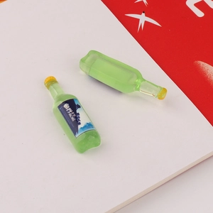 Macro view of miniature green resin beer bottles for dollhouse and DIY craft accessories