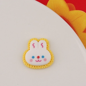 Close-up of cute white resin rabbit charm with pink cheeks for DIY craft phone cases