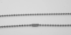 Macro detail of silver stainless steel ball chain with cylindrical connector clasp