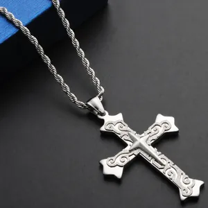 Macro shot of vintage stainless steel cross pendant with textured finish on rope chain