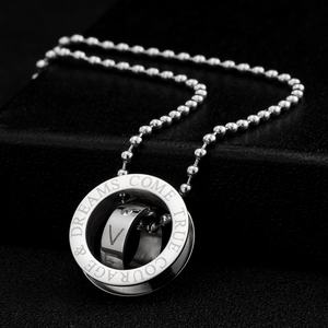 Detailed close-up of engraved stainless steel rings with crystal on a bead chain