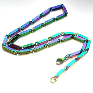 Macro detail of iridescent rainbow plating on stainless steel Cuban link chain necklace
