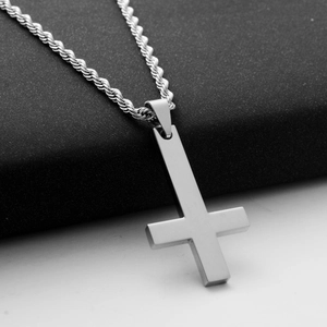 Detailed view of silver inverted cross pendant with brushed finish on thick twisted rope chain