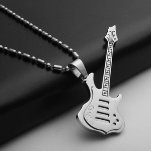 Macro shot of silver stainless steel electric guitar pendant with detailed engravings