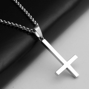 Detail view of a polished stainless steel inverted cross pendant on a pearl link chain