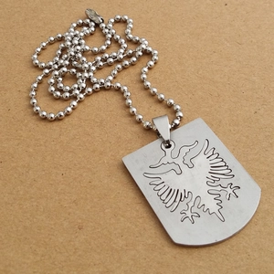 Detailed close-up of a silver stainless steel double-headed eagle shield pendant with ball chain