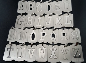 Detailed set of 26 stainless steel dog tag pendants with A-Z alphabet cutouts