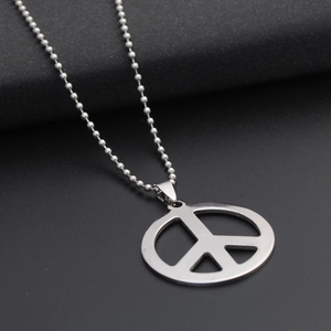 Polished stainless steel peace symbol necklace with ball chain on black background
