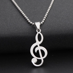 Detailed view of silver treble clef music note pendant on a beaded stainless steel chain
