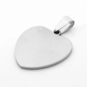 Macro detail of heart-shaped brushed stainless steel pendant with silver matte finish