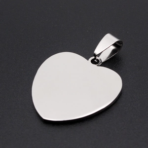 Close-up of heart-shaped stainless steel pendant with polished silver finish on black background