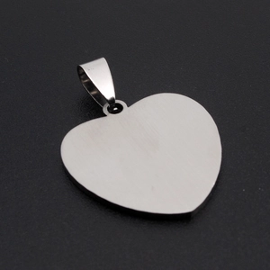 Close-up of heart-shaped stainless steel pendant with brushed silver metal finish