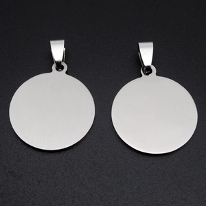 Close-up of two round brushed stainless steel dog tag pendants with polished silver finish