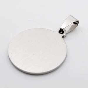 Macro detail of silver round pendant with a brushed stainless steel matte finish