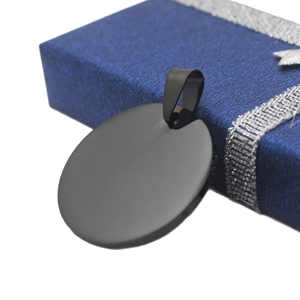 Minimalist round black stainless steel military pendant necklace on a gift box background