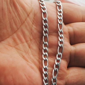 Handheld view of a classic silver stainless steel Figaro chain necklace for men and women