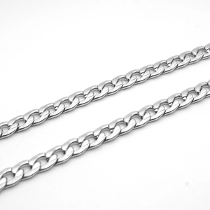 Macro shot of silver stainless steel curb chain with high-polished links and metallic texture