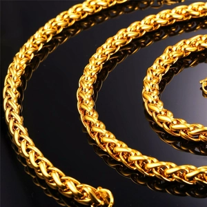 Close-up of thick gold-plated keel chain necklace with intricate woven wheat pattern