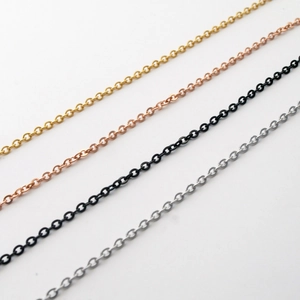 Detail of thin stainless steel O-chains in gold, rose gold, black, and silver finishes