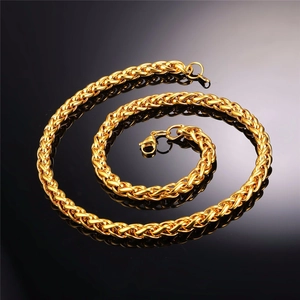Detailed view of golden stainless steel wheat chain necklace with secure lobster clasp
