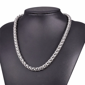 Polished silver stainless steel wheat chain necklace displayed on a black neck stand