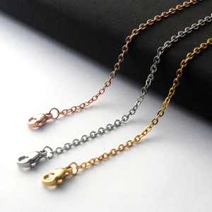 Detailed view of gold, rose gold and silver stainless steel cross chains with lobster clasps