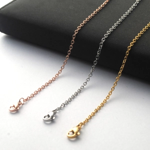 Detail of gold, rose gold, and silver stainless steel chains with lobster clasps