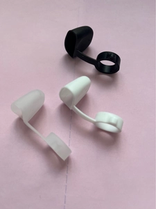 Detailed view of flexible silicone anti-dust caps for e-cigarettes in black and white