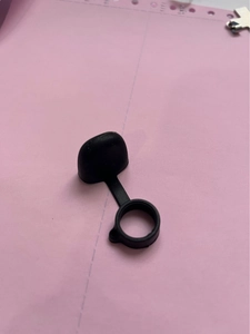 Macro detail of the matte black silicone anti-lost dust cap for electronic accessories