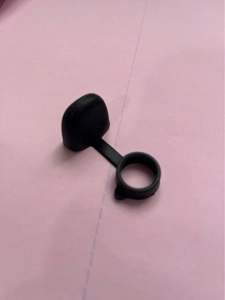 Close-up of black silicone dust cap with anti-lost ring for electronic device mouthpieces