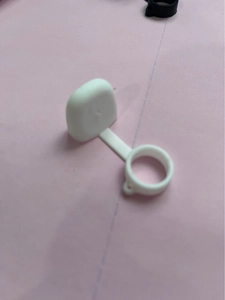 Macro view of white silicone dust cap protector with integrated ring for vape pen