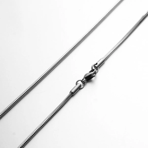 Close-up of sleek silver snake chain necklace with high-polish finish and lobster clasp