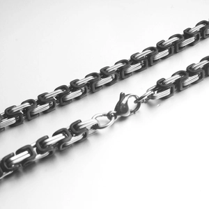 Detailed close-up of Byzantine style square link bracelet with silver and black metal weave