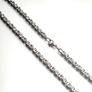Macro detail of silver Byzantine style stainless steel chain with secure lobster clasp