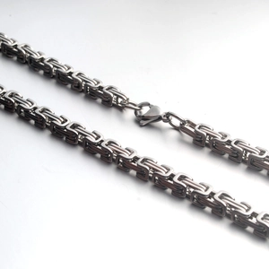 Close-up of a silver stainless steel Byzantine chain necklace with a secure lobster clasp