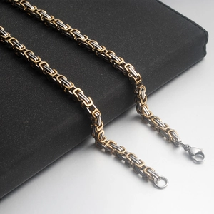 Macro detail of bicolor Byzantine weave stainless steel bracelet with lobster clasp